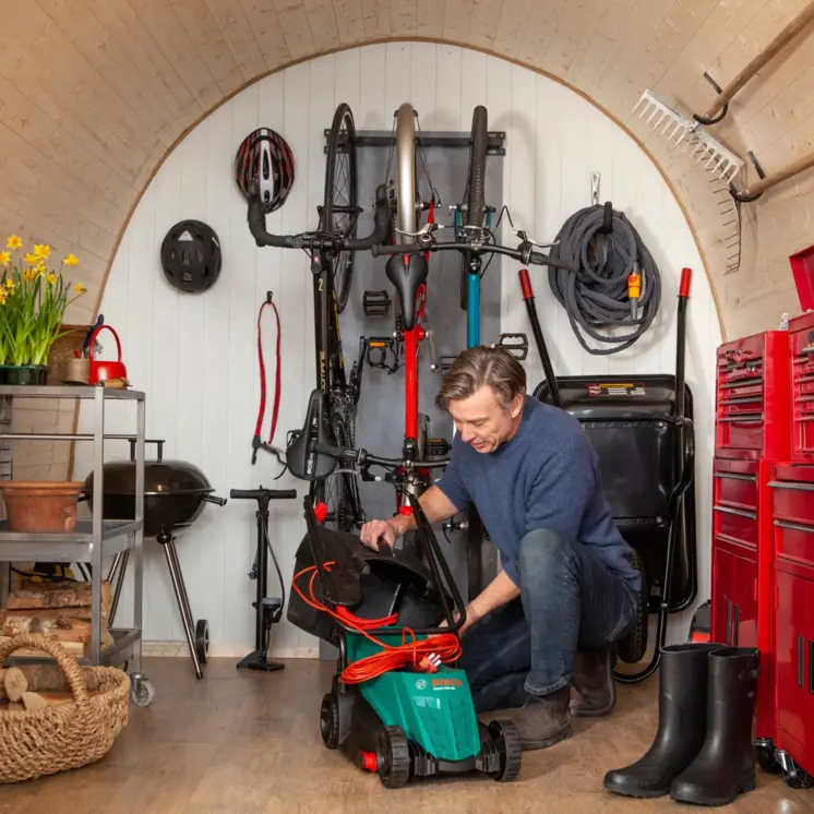 Garden room with storage and built-in shelves and hooks.