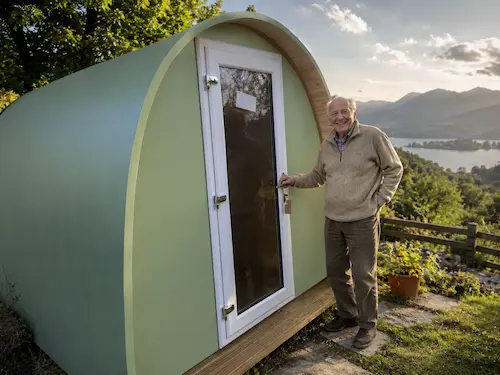 an elderly man next to granny pod purchased at Hully
